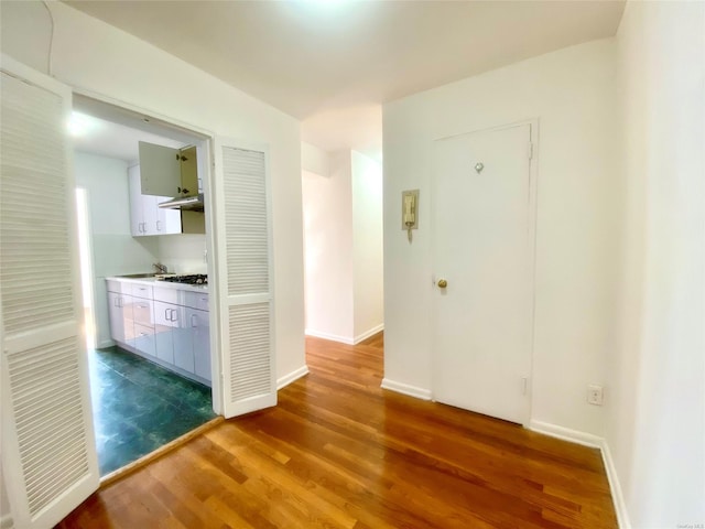 corridor with dark hardwood / wood-style floors