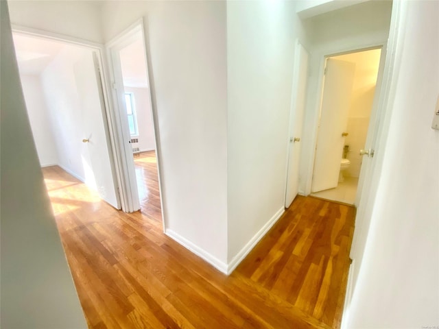 corridor featuring hardwood / wood-style floors