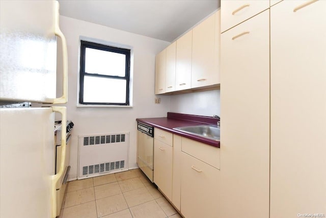 kitchen featuring white appliances, radiator, and sink