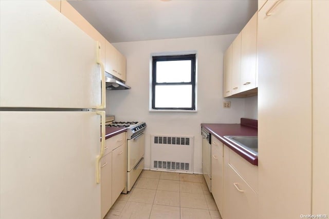 kitchen with radiator heating unit, white appliances, and sink