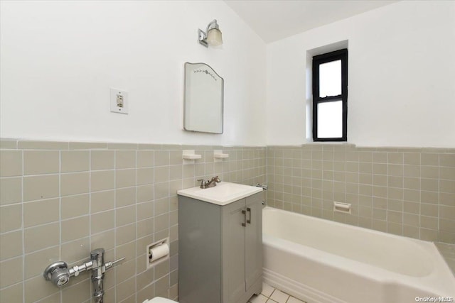 bathroom with tile patterned flooring, a bath, vanity, and tile walls