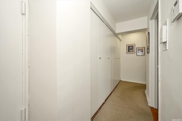 corridor with light colored carpet