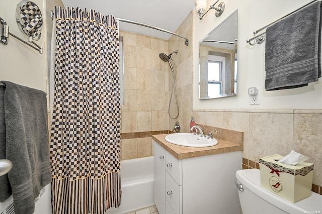 full bathroom with tiled shower / bath, vanity, toilet, and tile walls