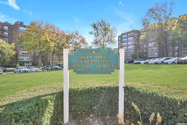 community / neighborhood sign with a lawn