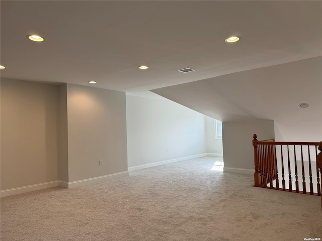 bonus room featuring light colored carpet