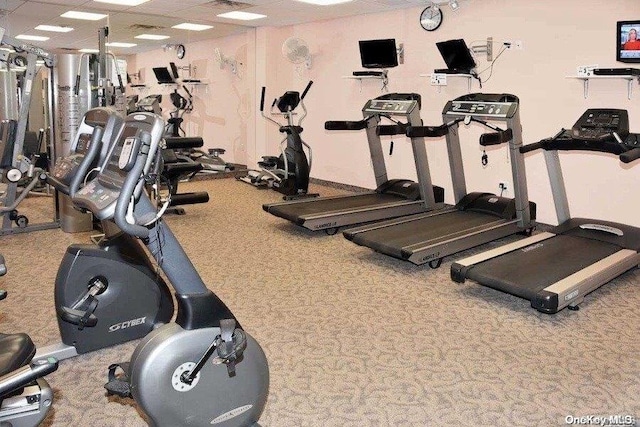 workout area with carpet flooring and a paneled ceiling