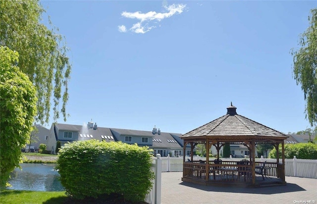 surrounding community featuring a gazebo and a water view