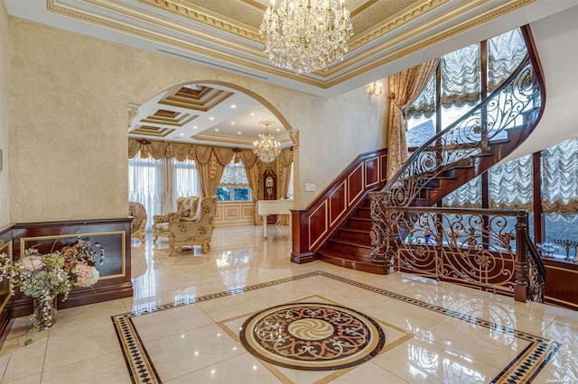 entryway featuring ornamental molding, a towering ceiling, and coffered ceiling