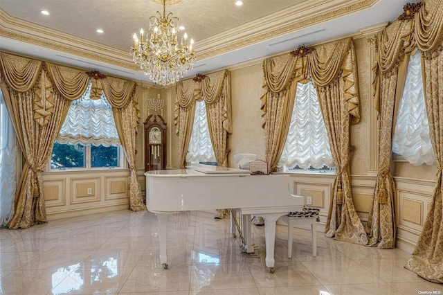 miscellaneous room with a tray ceiling, an inviting chandelier, and ornamental molding