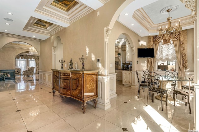 interior space featuring light tile patterned floors, a chandelier, and ornamental molding