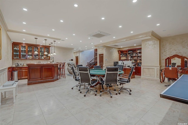 tiled dining room featuring crown molding and bar