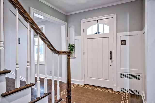 entrance foyer featuring dark hardwood / wood-style flooring, radiator, and ornamental molding