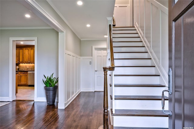 stairs with wood-type flooring and crown molding