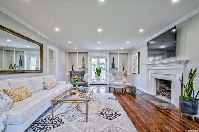 living room featuring a fireplace, ornamental molding, and hardwood / wood-style flooring