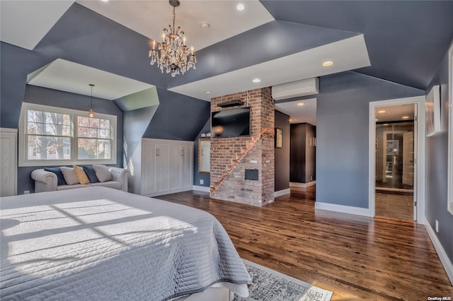 bedroom with dark hardwood / wood-style flooring, an AC wall unit, a fireplace, and vaulted ceiling