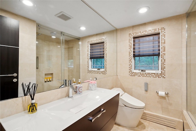 bathroom with vanity, tile patterned floors, and tile walls