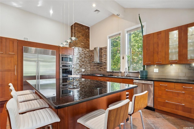 kitchen with built in appliances, a kitchen breakfast bar, a kitchen island, and tasteful backsplash