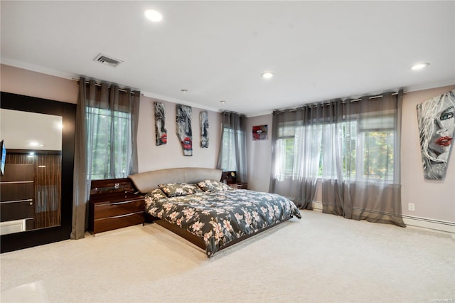 carpeted bedroom with ornamental molding