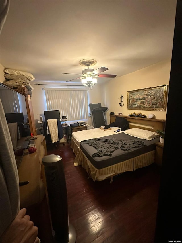 bedroom with ceiling fan and dark wood-type flooring