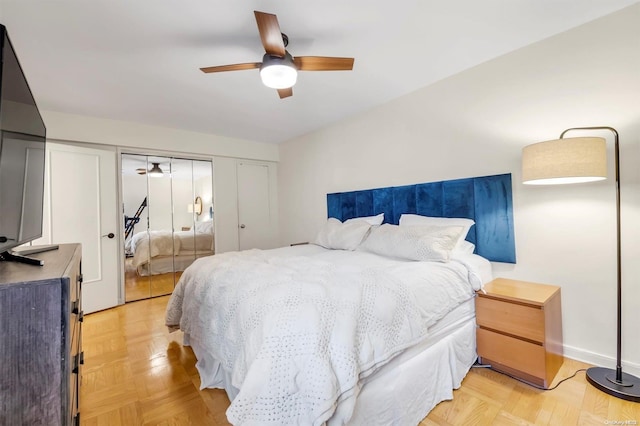 bedroom featuring ceiling fan, light parquet floors, and a closet