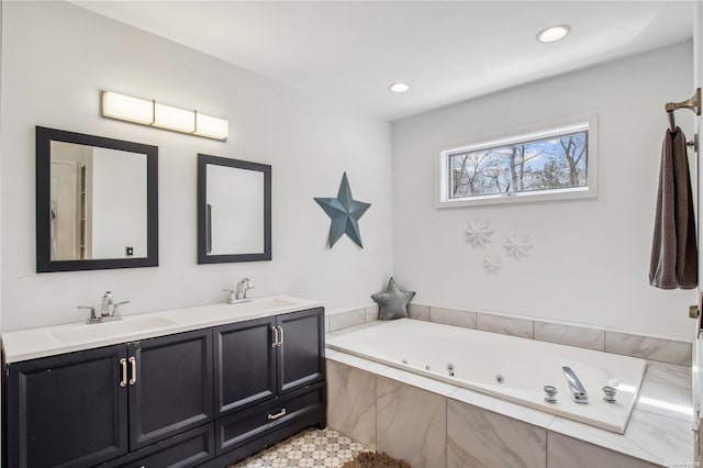 bathroom with tiled tub and vanity