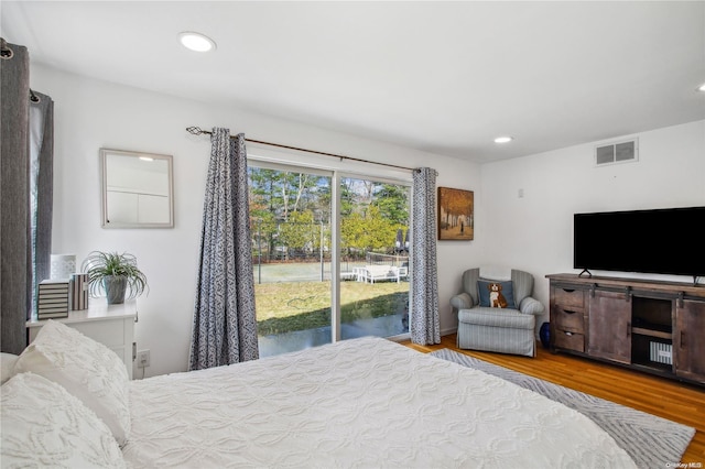 bedroom featuring access to exterior and light wood-type flooring