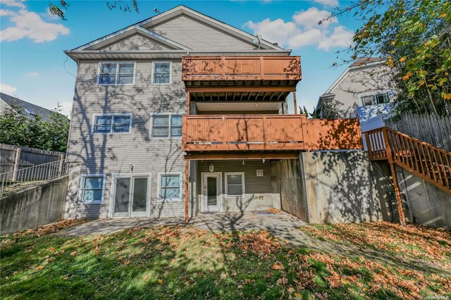 back of property featuring a patio area and a yard