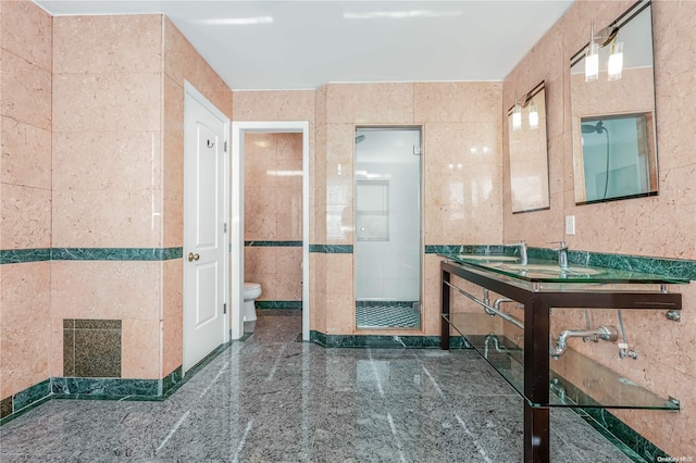 bathroom with toilet and tile walls