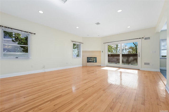 unfurnished living room featuring light hardwood / wood-style flooring