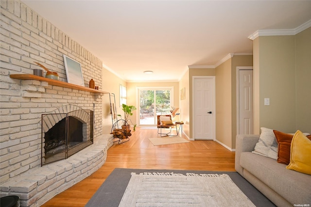 living room featuring a fireplace, ornamental molding, and wood-type flooring