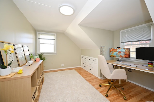 office space with light hardwood / wood-style flooring and vaulted ceiling