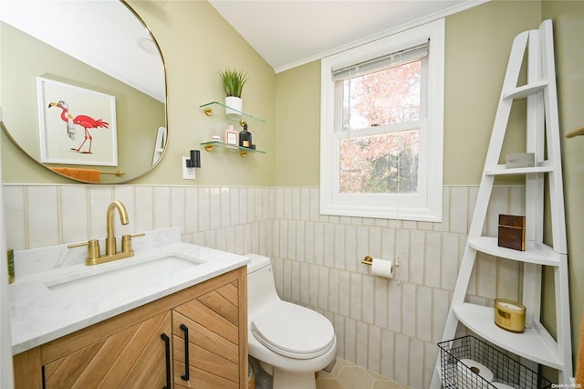 bathroom featuring toilet, lofted ceiling, a healthy amount of sunlight, and vanity