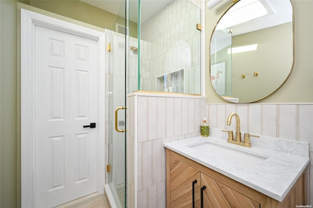 bathroom with vanity and a shower with shower door