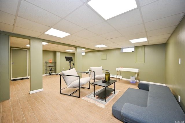 living room featuring light hardwood / wood-style floors, a paneled ceiling, and a baseboard radiator