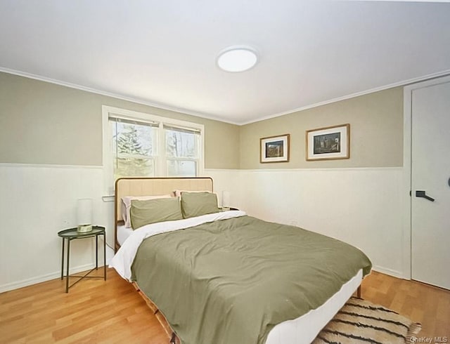 bedroom with crown molding and wood-type flooring