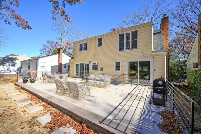 back of property featuring a patio area and an outdoor living space