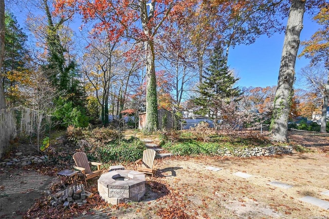 view of yard featuring an outdoor fire pit