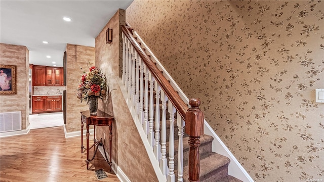 stairway featuring wood-type flooring