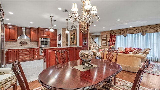 dining area featuring light hardwood / wood-style floors and an inviting chandelier