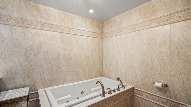 bathroom with tile walls and tiled bath