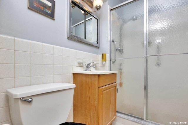 18-75 Corporal Kennedy St Unit 2F, Bayside, NY 11360 - full bath featuring toilet, a stall shower, vanity, tile walls, and wainscoting