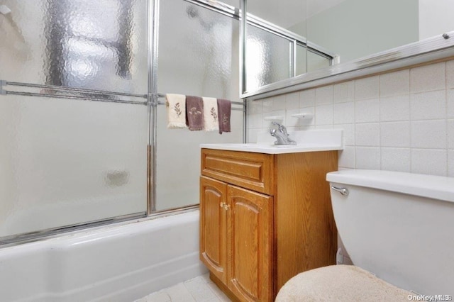 18-75 Corporal Kennedy St Unit 2F, Bayside, NY 11360 - full bathroom with toilet, combined bath / shower with glass door, vanity, backsplash, and tile patterned floors