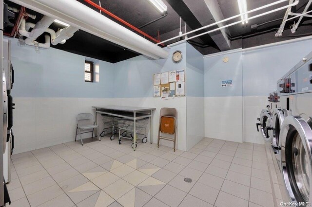 18-75 Corporal Kennedy St Unit 2F, Bayside, NY 11360 - washroom with separate washer and dryer, wainscoting, and tile patterned floors