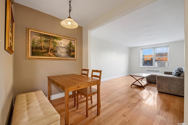 dining room featuring light hardwood / wood-style floors and radiator