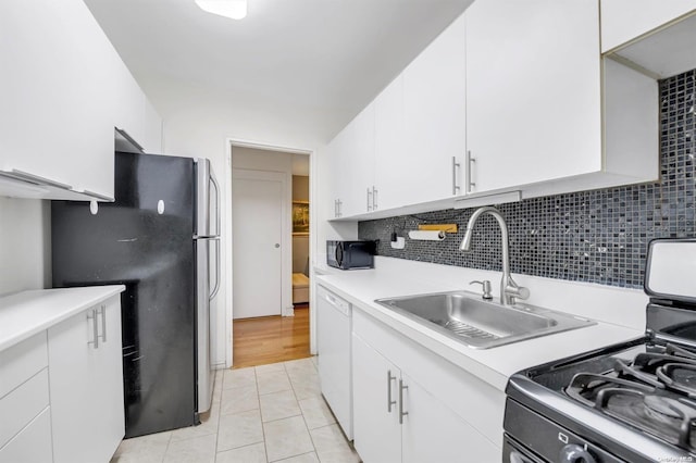 kitchen with stainless steel fridge, stove, backsplash, dishwasher, and white cabinets