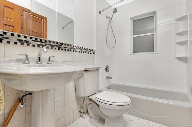 bathroom with tasteful backsplash, bathtub / shower combination, tile patterned floors, toilet, and tile walls