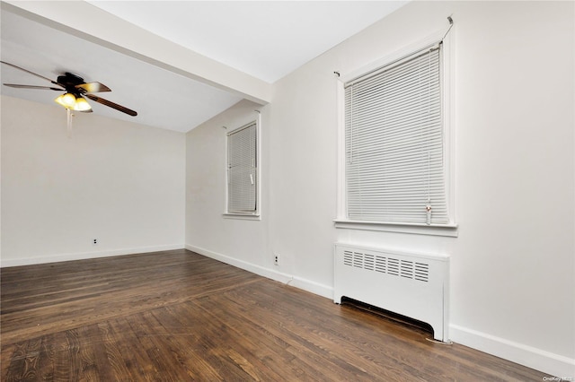 empty room with radiator, ceiling fan, and dark hardwood / wood-style flooring