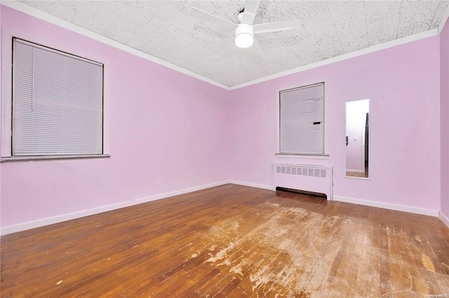 unfurnished room featuring wood-type flooring, radiator, ornamental molding, and ceiling fan