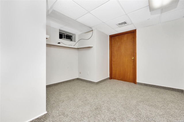 basement with light carpet and a drop ceiling