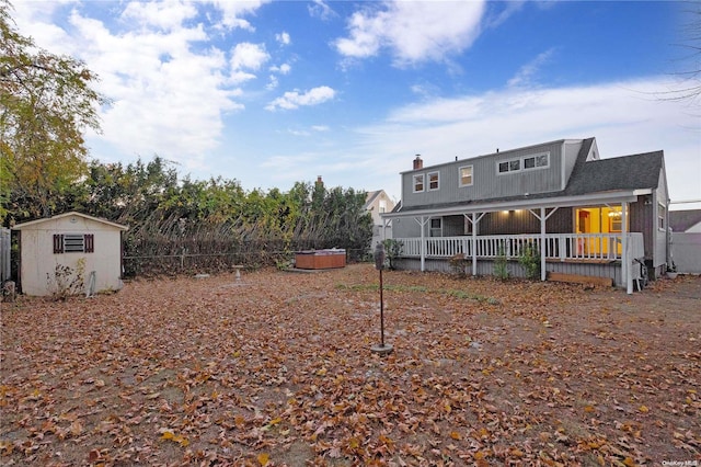 exterior space with a hot tub and a storage unit